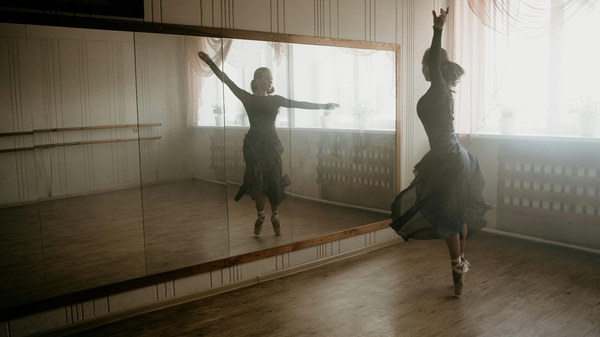 Woman practicing gentle movements in a bright airy studio